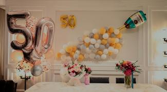 yellow and white balloons on table by Lucas Law courtesy of Unsplash.